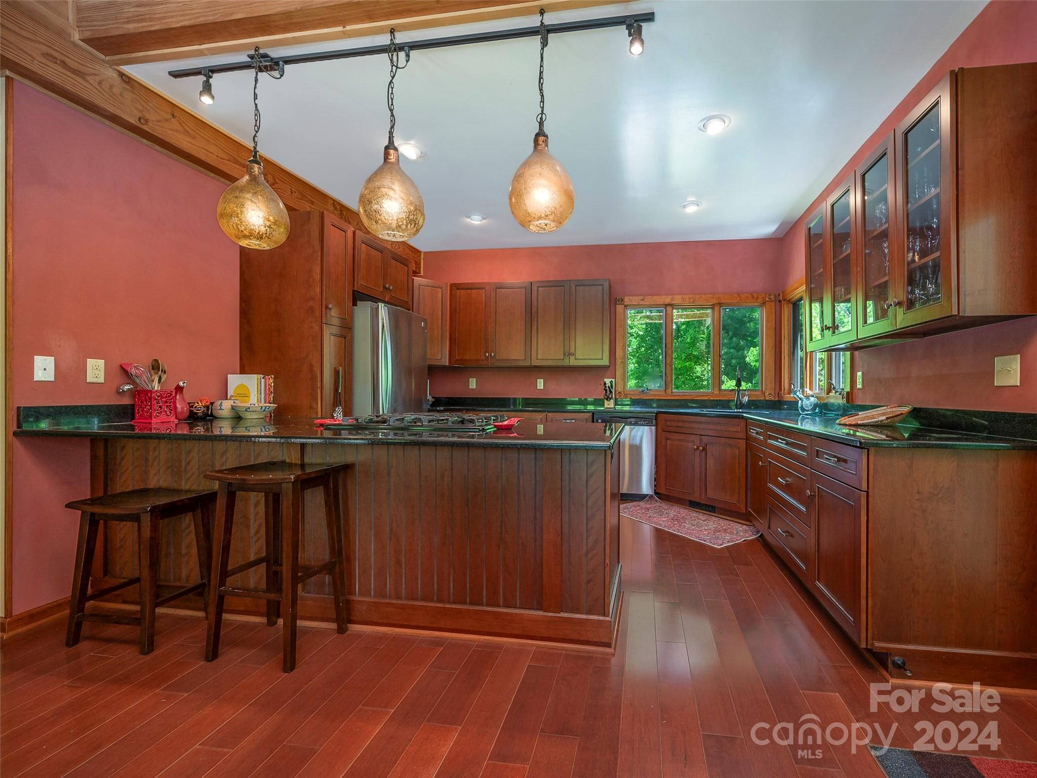 58 Next To The Last Road Saluda, NC 28773 - Photo 12 of 48 a kitchen with stainless steel appliances granite countertop a stove a sink and a wooden floors