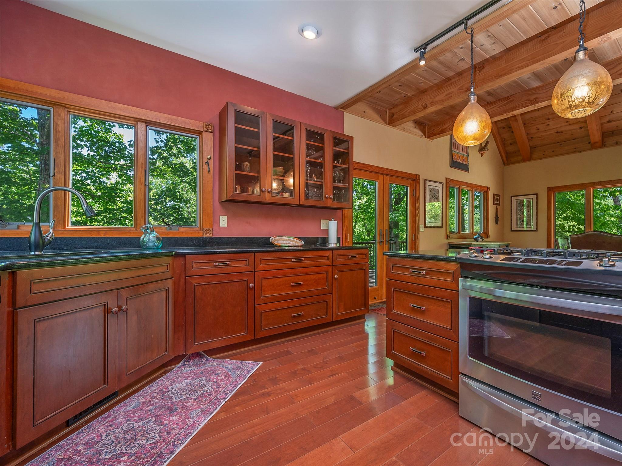 58 Next To The Last Road Saluda, NC 28773 - Photo 13 of 48 a kitchen with stainless steel appliances granite countertop a stove and cabinets