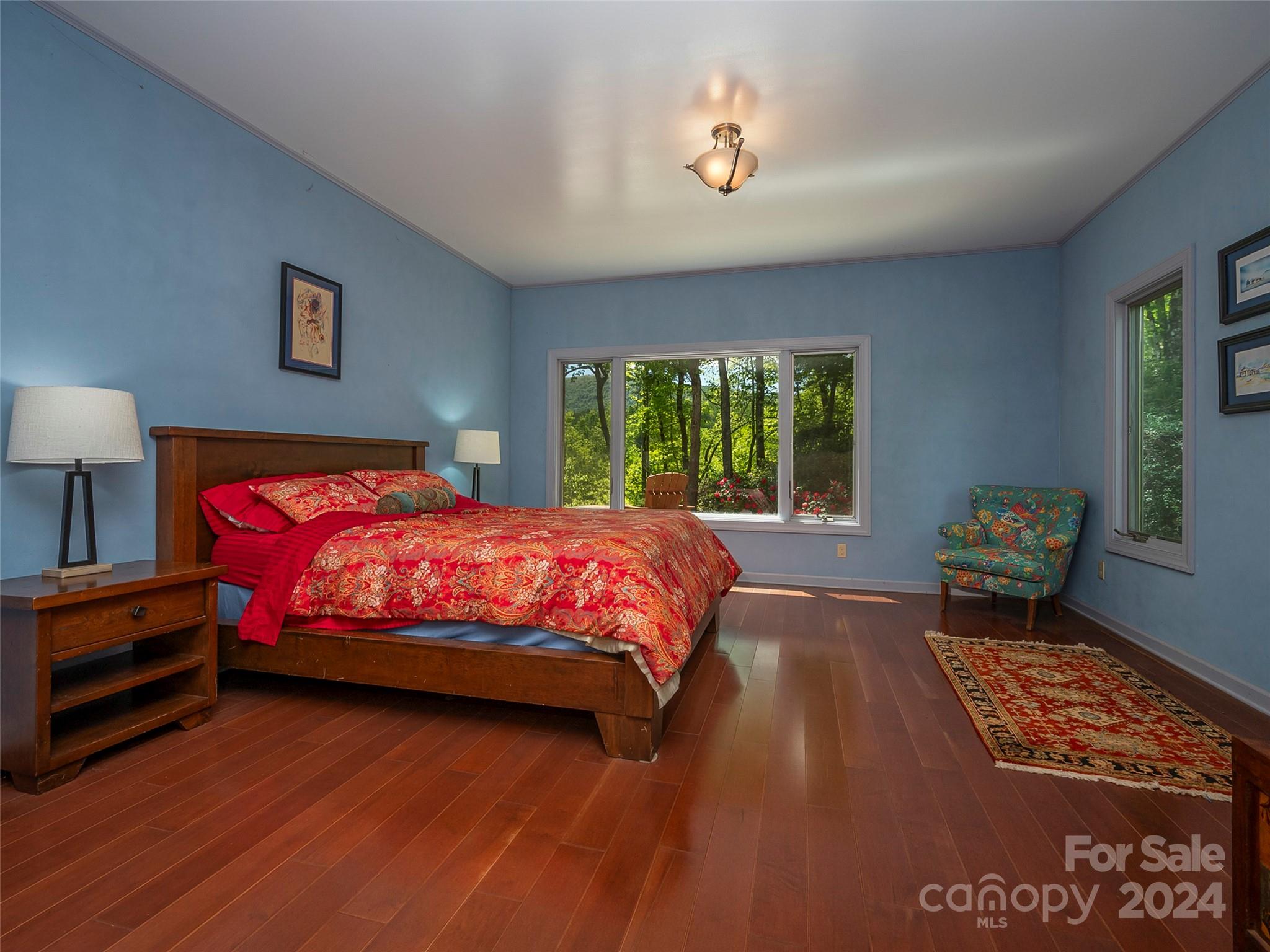 58 Next To The Last Road Saluda, NC 28773 - Photo 19 of 48 a spacious bedroom with a bed and a window