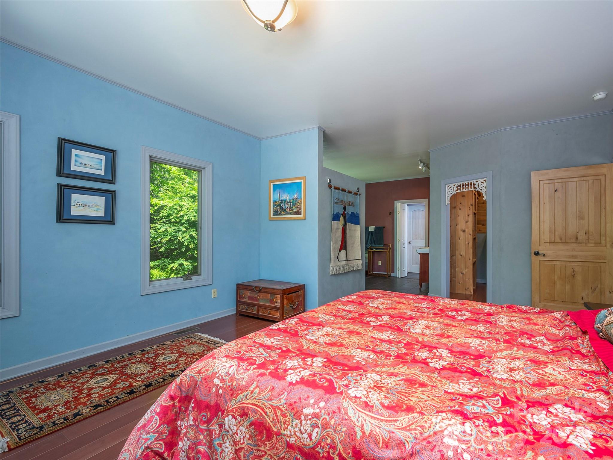 58 Next To The Last Road Saluda, NC 28773 - Photo 20 of 48 a bed sitting in a bedroom next to a window