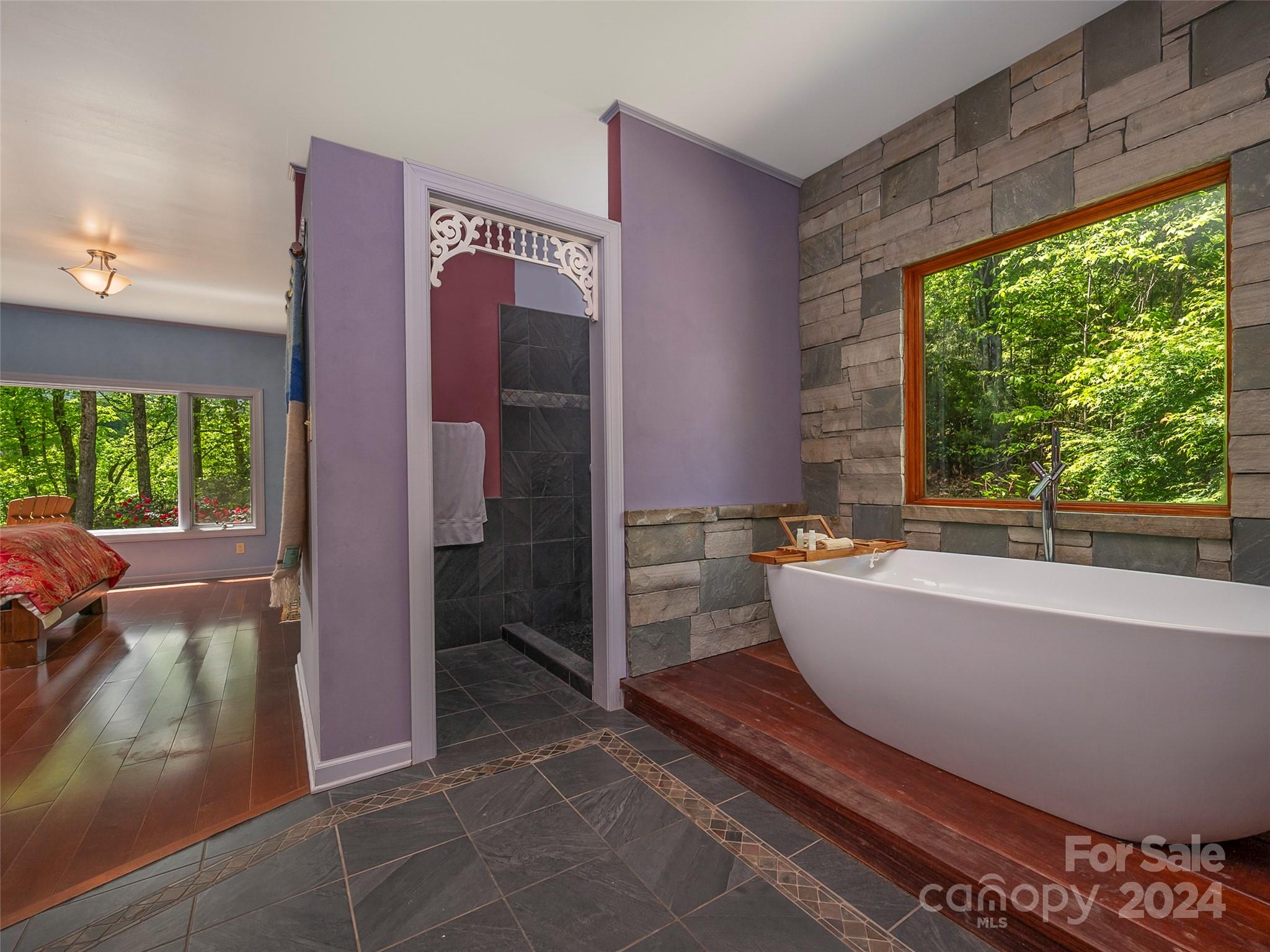 58 Next To The Last Road Saluda, NC 28773 - Photo 23 of 48 a bathroom with a bathtub and a shower
