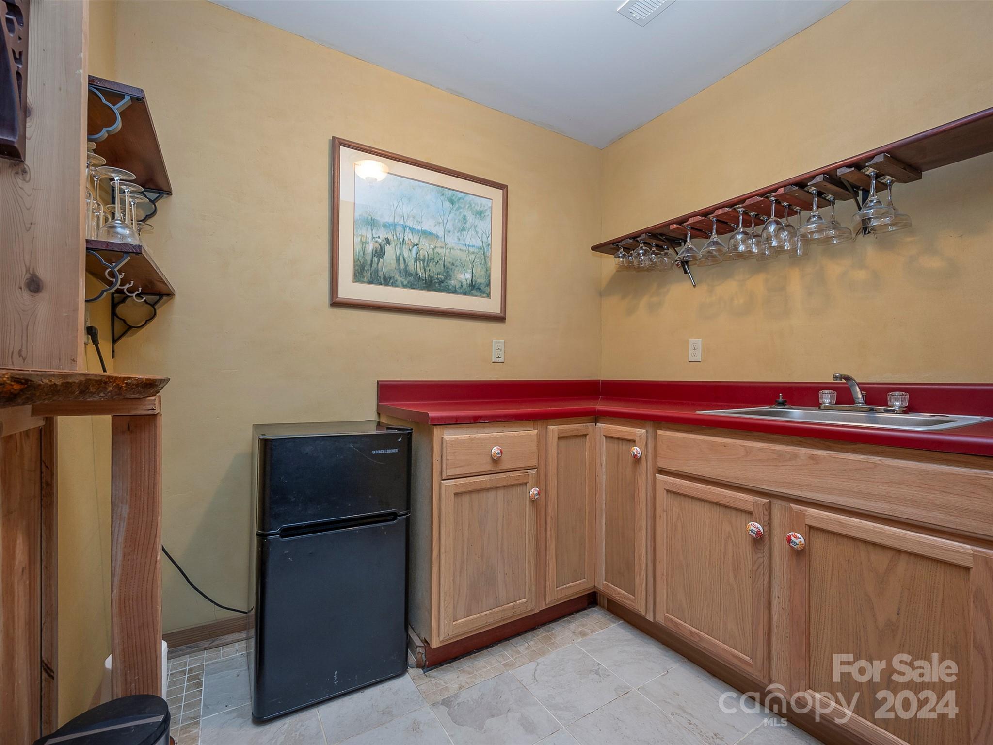 58 Next To The Last Road Saluda, NC 28773 - Photo 26 of 48 a kitchen with a refrigerator and cabinets