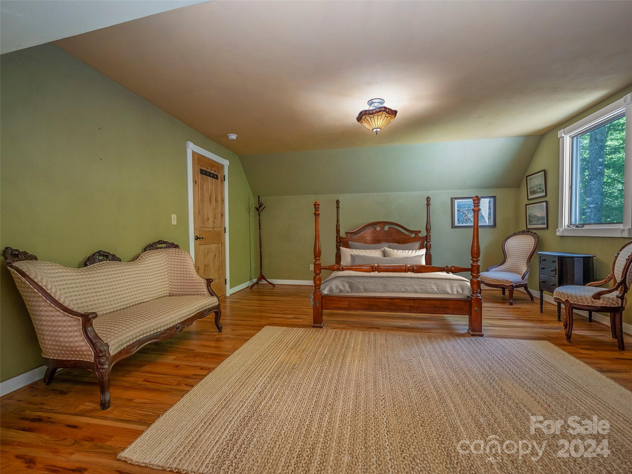 58 Next To The Last Road Saluda, NC 28773 - Photo 28 of 48 a bedroom with furniture and wooden floor