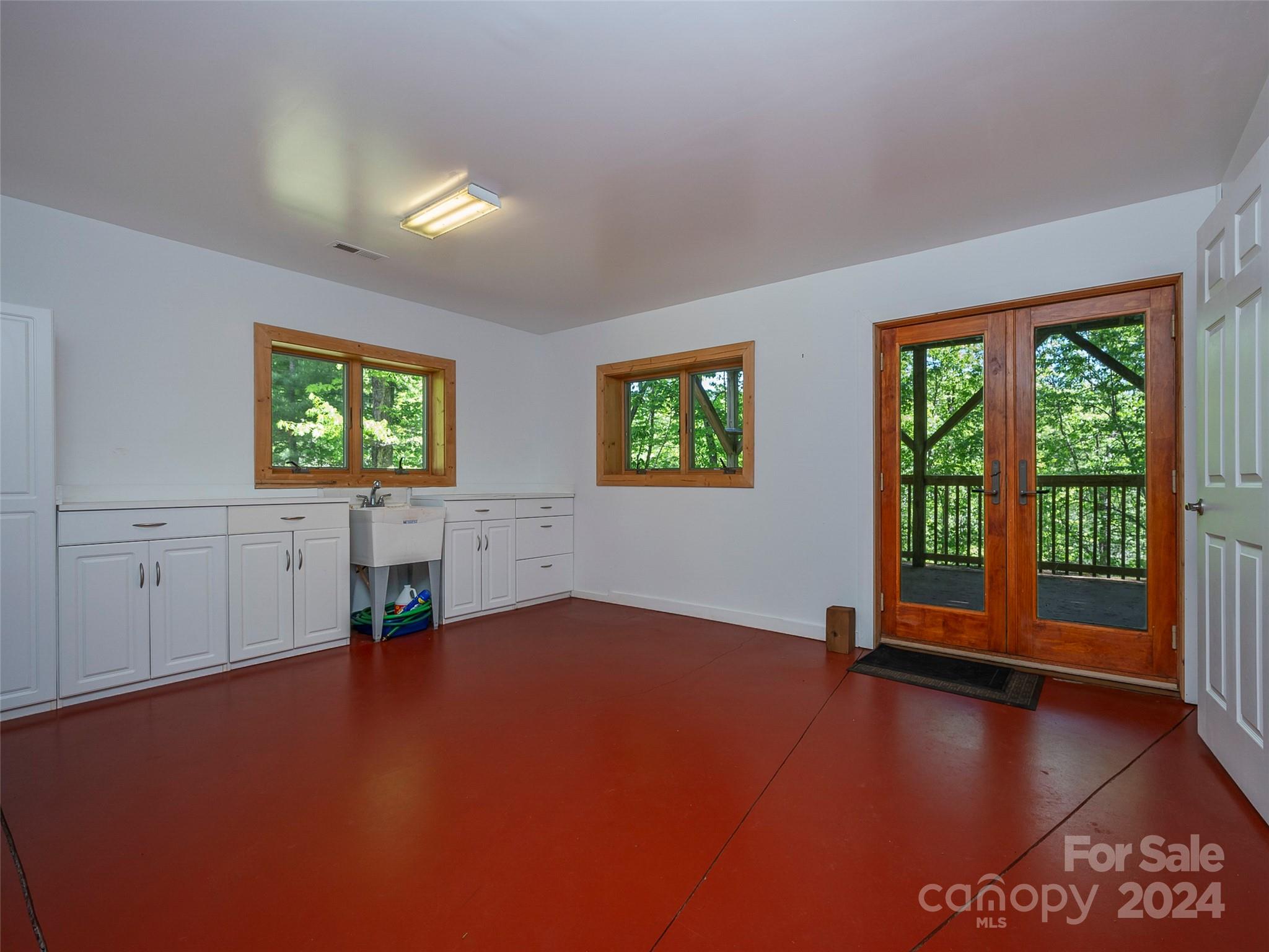58 Next To The Last Road Saluda, NC 28773 - Photo 36 of 48 a view of an empty room with window wooden floor and front door