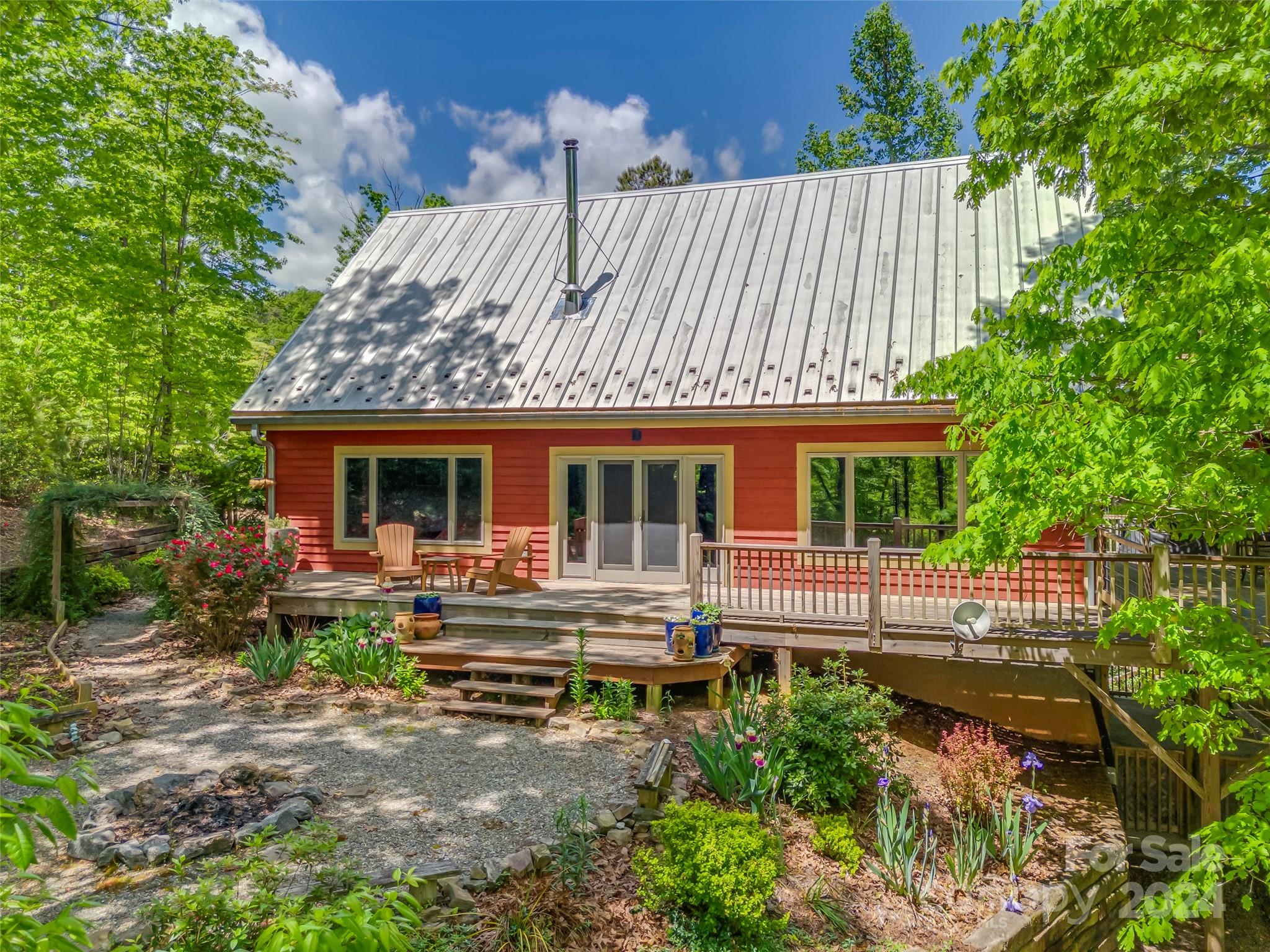 58 Next To The Last Road Saluda, NC 28773 - Photo 38 of 48 a front view of a house with garden