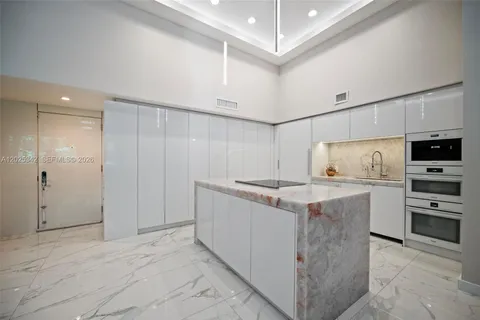 a kitchen with stainless steel appliances a stove microwave and sink
