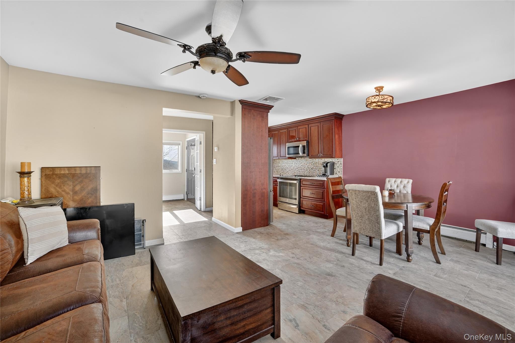 20 Beecher Lane Peekskill, NY 10566 - Photo 14 of 35 a living room with furniture kitchen view and a chandelier