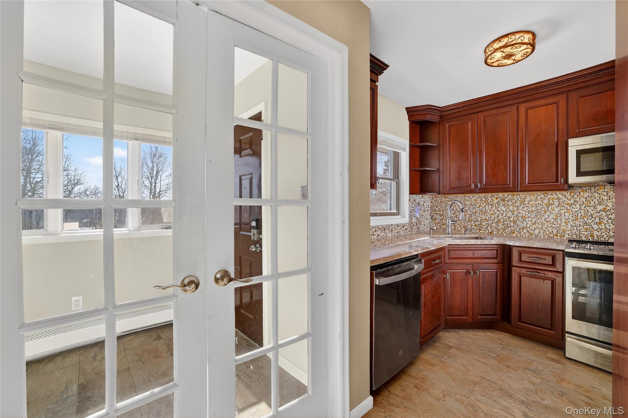 20 Beecher Lane Peekskill, NY 10566 - Photo 7 of 35 a kitchen with stainless steel appliances granite countertop a refrigerator and a stove top oven