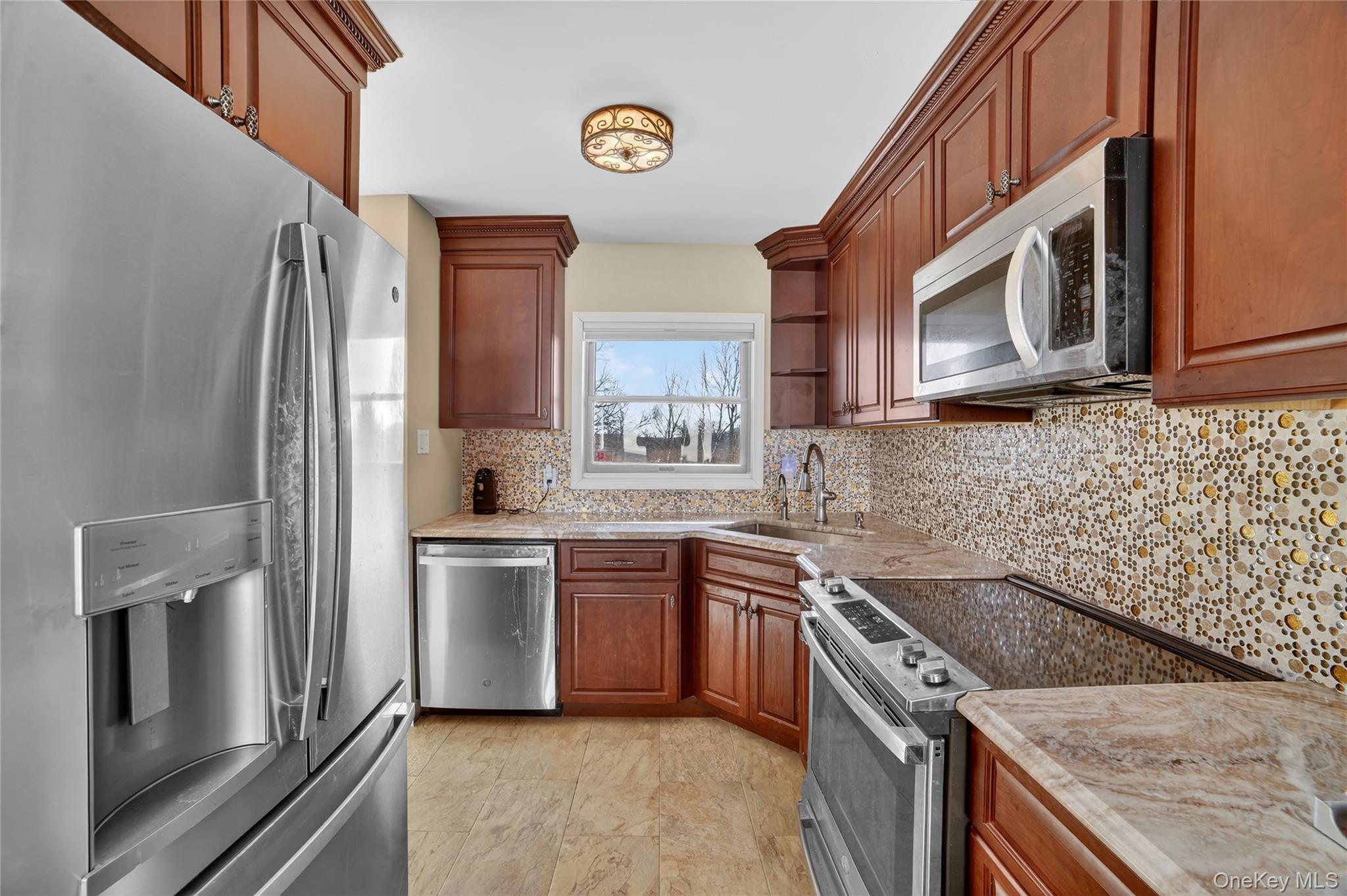 20 Beecher Lane Peekskill, NY 10566 - Photo 10 of 35 a kitchen with stainless steel appliances granite countertop a refrigerator stove and sink