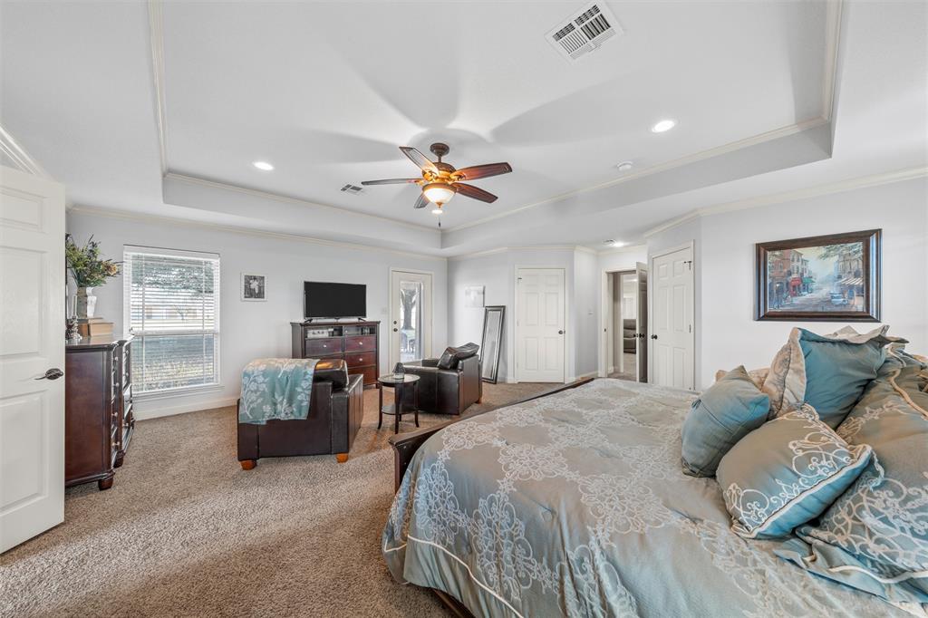 231 Trlica Road West, TX 76691 - Photo 15 of 36 a bedroom with a bed a couch and a chandelier