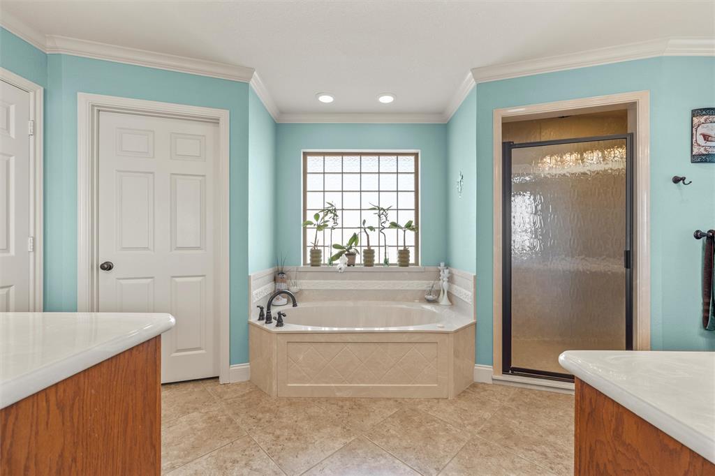 231 Trlica Road West, TX 76691 - Photo 16 of 36 a spacious bathroom with a tub shower and a sink