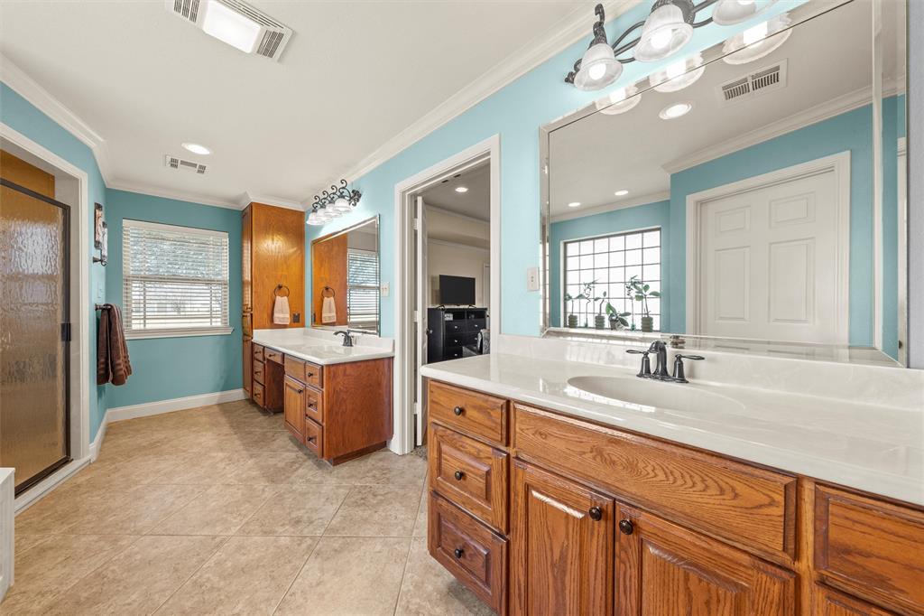 231 Trlica Road West, TX 76691 - Photo 17 of 36 a spacious bathroom with a granite countertop sink a mirror a bathtub and shower