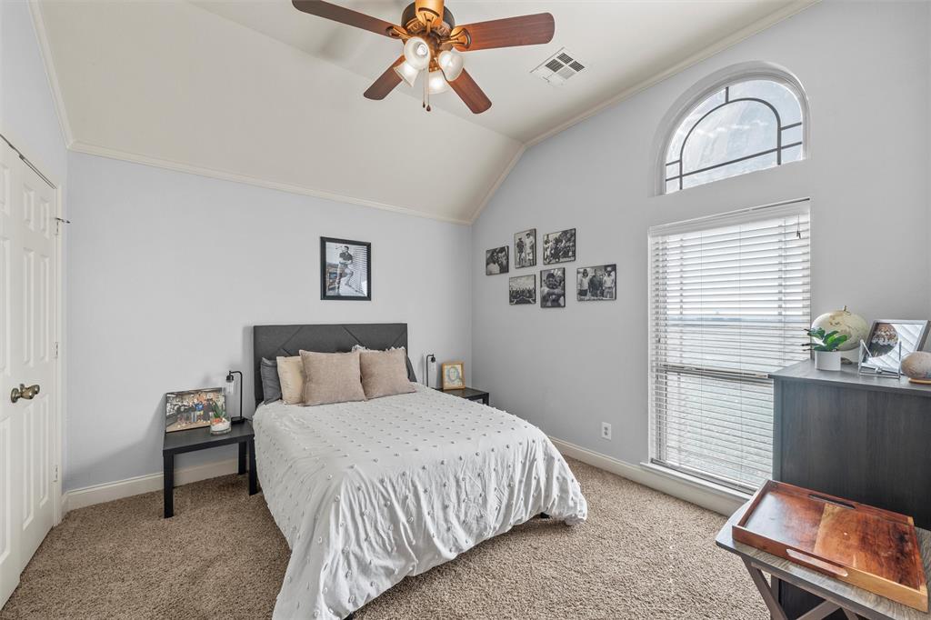 231 Trlica Road West, TX 76691 - Photo 17 of 36 a bedroom with a bed and a chandelier