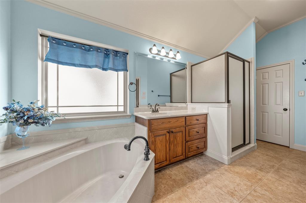 231 Trlica Road West, TX 76691 - Photo 22 of 36 a spacious bathroom with a tub sink shower and mirror