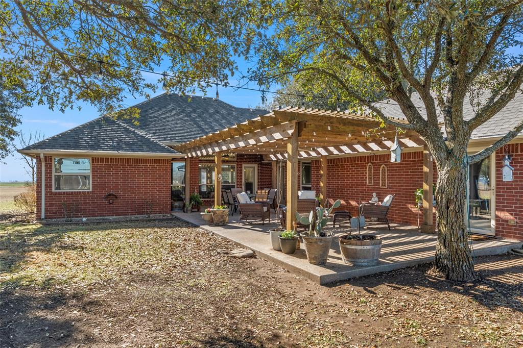 231 Trlica Road West, TX 76691 - Photo 27 of 36 a view of a house with backyard porch and sitting area
