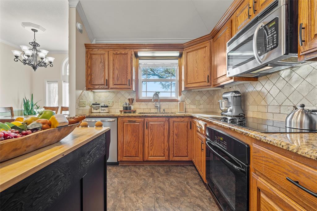 231 Trlica Road West, TX 76691 - Photo 7 of 36 a kitchen with stainless steel appliances granite countertop a sink stove and cabinets