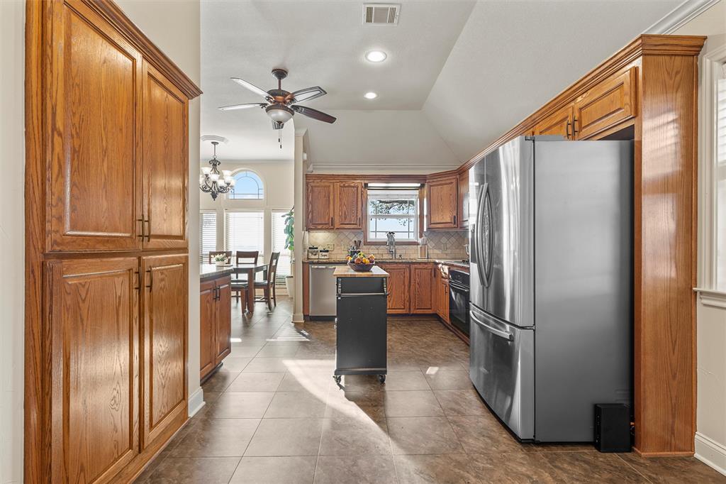 231 Trlica Road West, TX 76691 - Photo 10 of 36 a kitchen with stainless steel appliances a refrigerator and cabinets