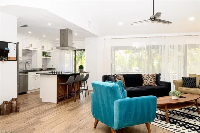 a living room with furniture and kitchen view