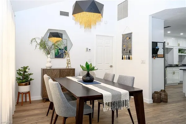 a dining room with furniture and wooden floor