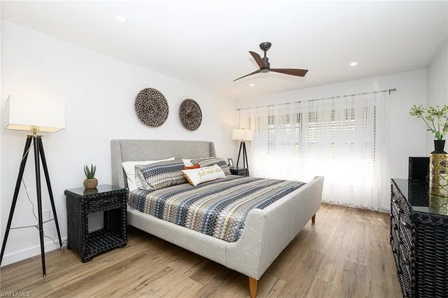 a bedroom with a bed and a flat tv screen on a dresser