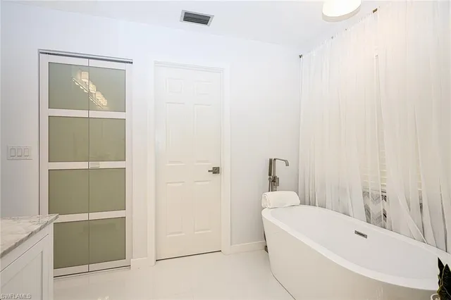 a bathroom with a bathtub and shower