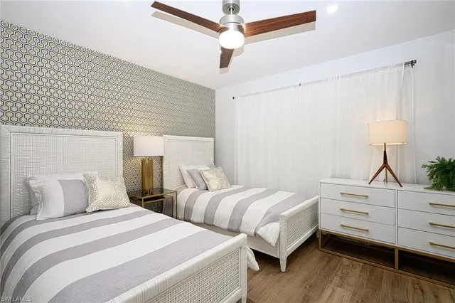 a bedroom with two beds and a dresser