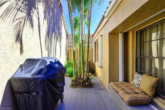 a living room with a couch and a potted plant with the outer view
