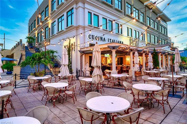 a view of a patio with chairs and potted plants
