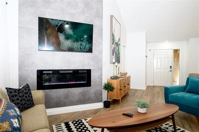 a living room with furniture and a fireplace