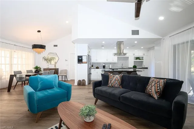 a view of a living room kitchen and a wooden floor