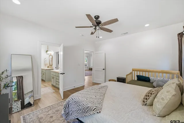 a bedroom with a bed and a mirror