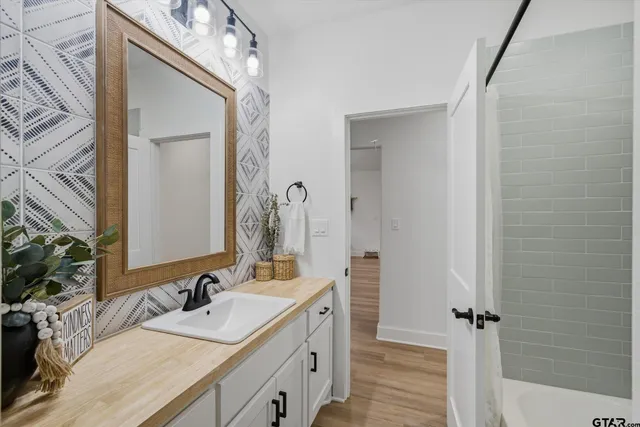 a bathroom with a double vanity sink and a mirror