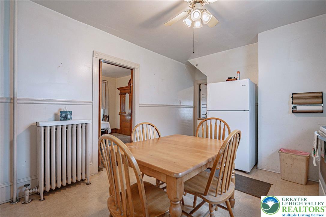 159 West Ridge Street Nesquehoning, PA 18240 - Photo 17 of 55 A well-lit dining area featuring classic wainscoting and convenient kitchen access.