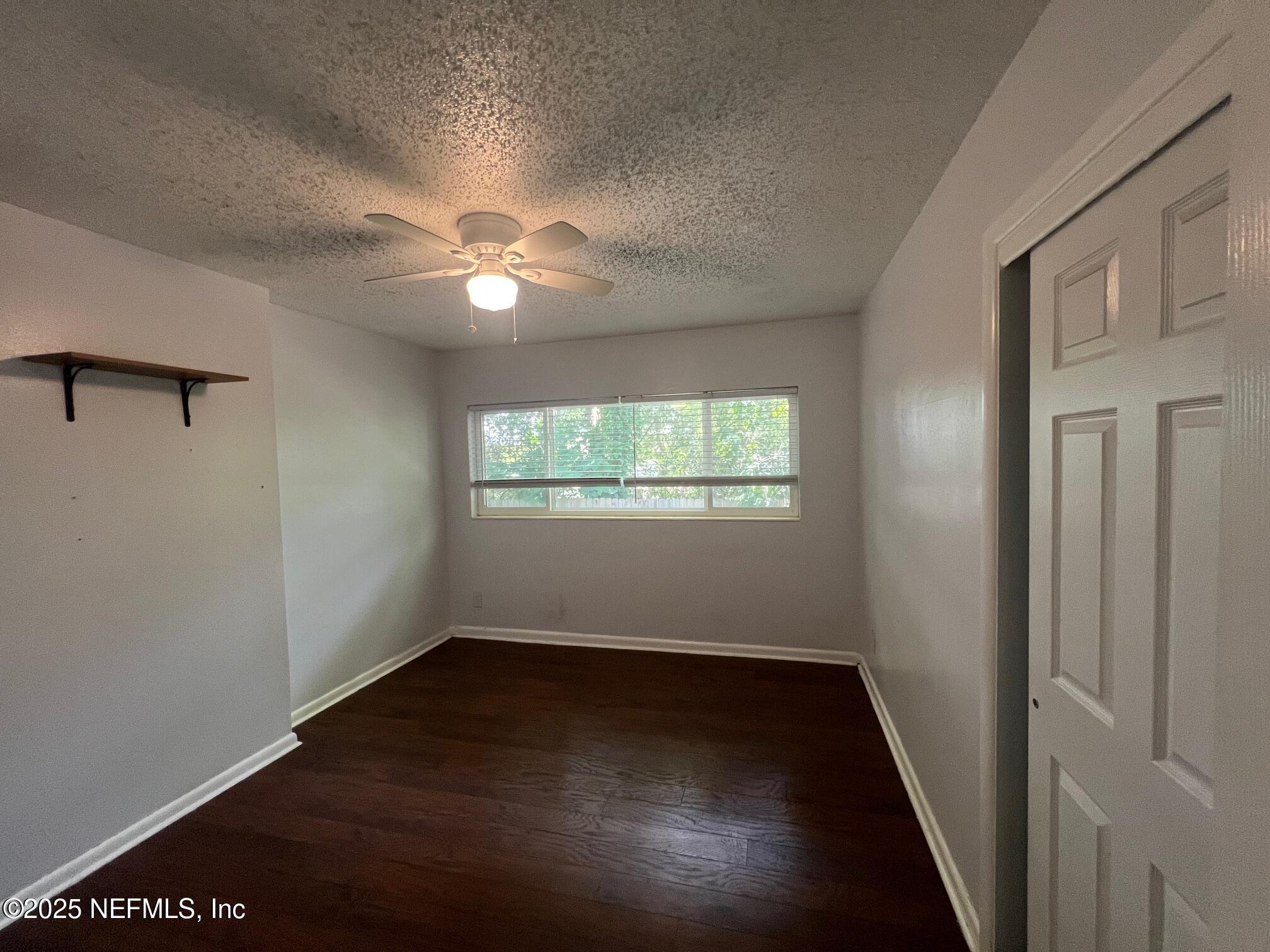 6231 Riviera Manor Drive Jacksonville, FL 32216 - Photo 15 of 15 an empty room with wooden floor and windows