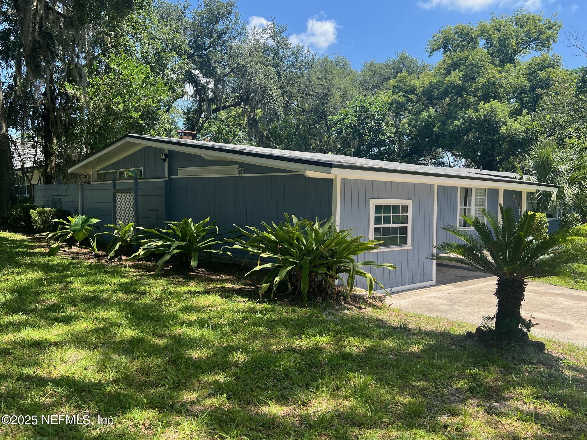6231 Riviera Manor Drive Jacksonville, FL 32216 - Photo 2 of 15 a view of a house with a yard and plants