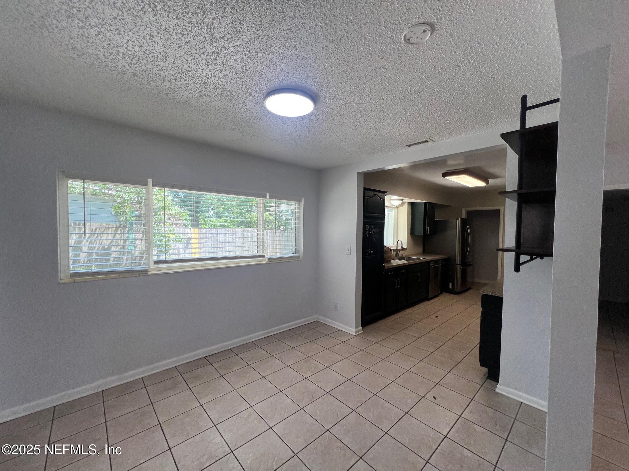 6231 Riviera Manor Drive Jacksonville, FL 32216 - Photo 8 of 15 a view of a big room with windows and chandelier