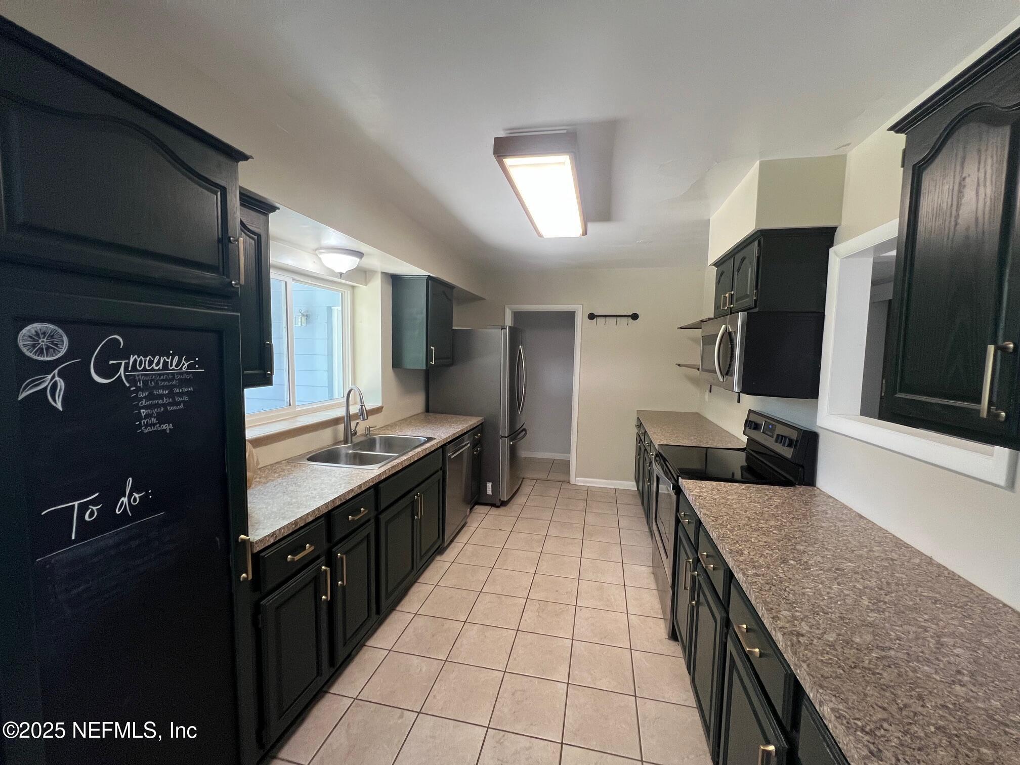 6231 Riviera Manor Drive Jacksonville, FL 32216 - Photo 9 of 15 a kitchen with stainless steel appliances granite countertop a sink stove and refrigerator