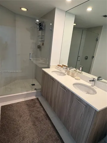 a bathroom with a tub sink and mirror