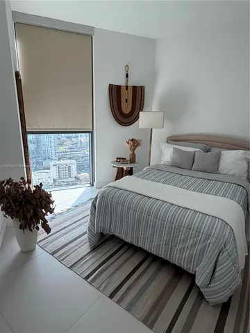 a bedroom with bed and window