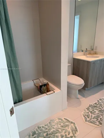 a bathroom with a sink a toilet a tub and shower
