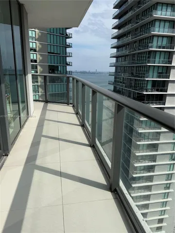 a view of balcony with wooden floor and windows
