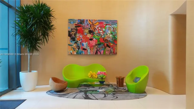 a view of a dining room with furniture and a potted plant