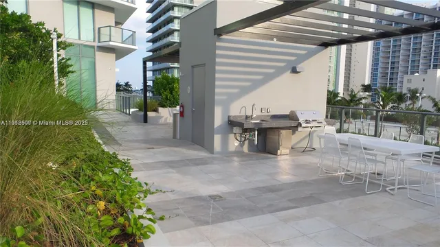 a view of a patio with a table and chairs and potted plants
