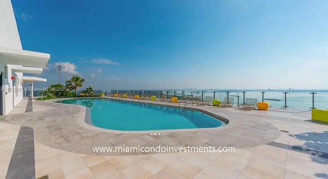 a view of a swimming pool with a lounge chair