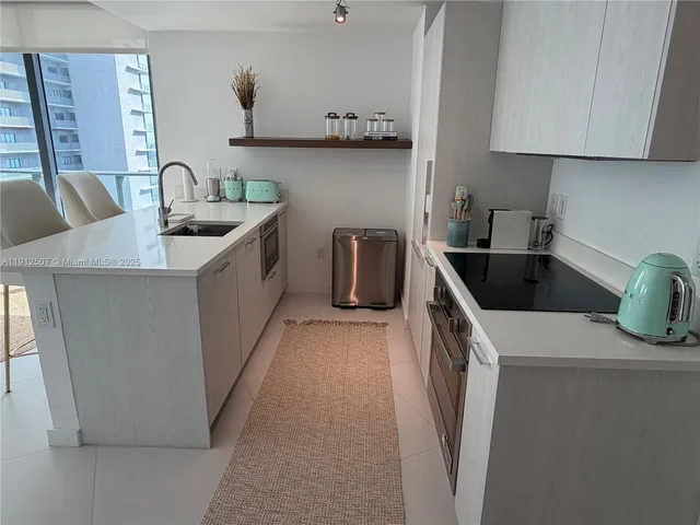 a kitchen that has a sink and a stove