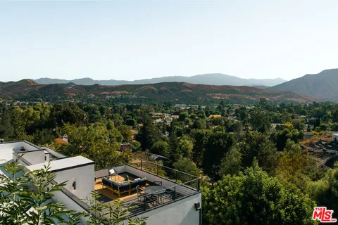 an aerial view of a house with a mountain view