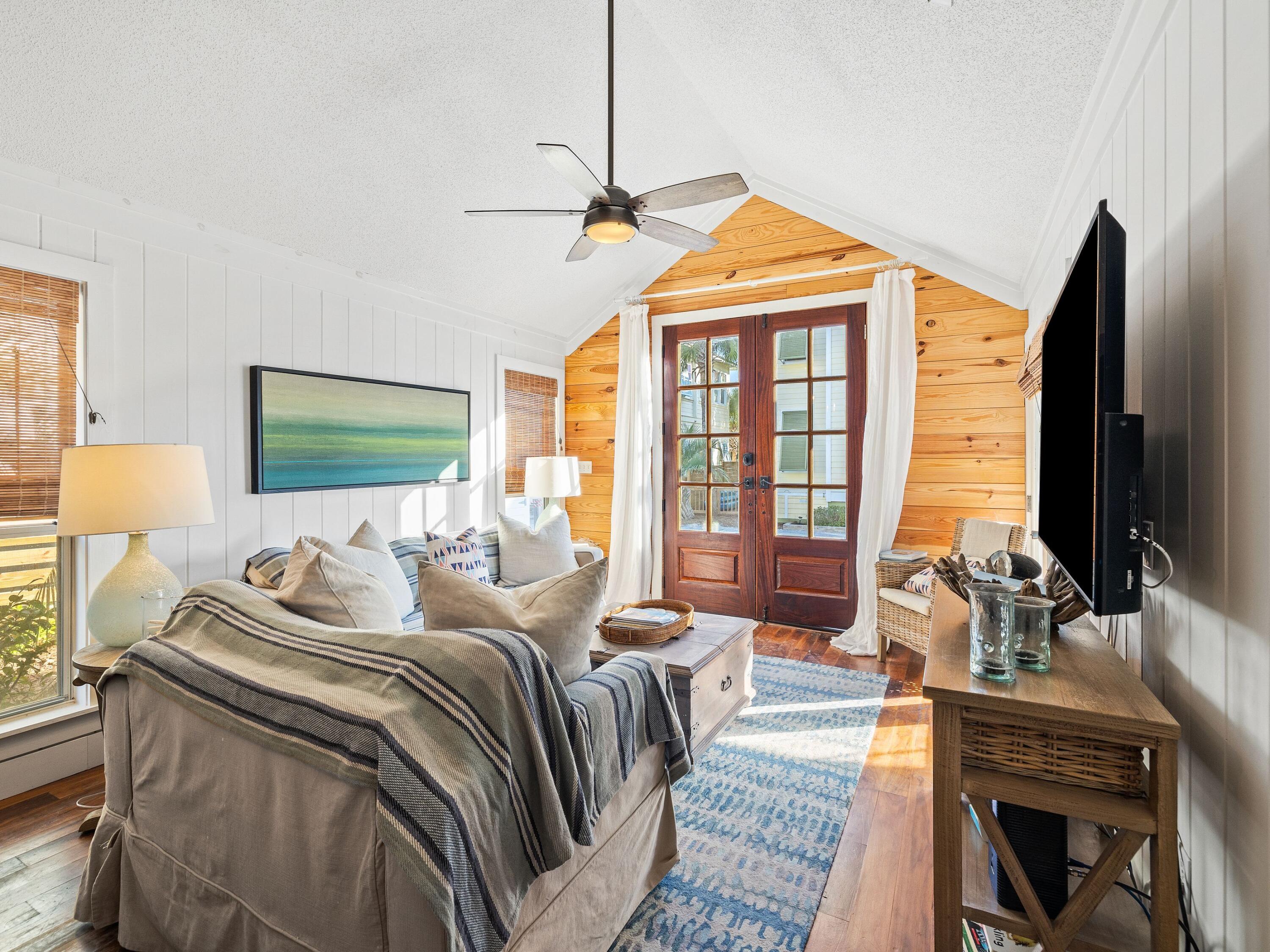 50 Cottage Street Santa Rosa Beach, FL 32459 - Photo 22 of 54 a bedroom with a bed a flat screen tv and a large window