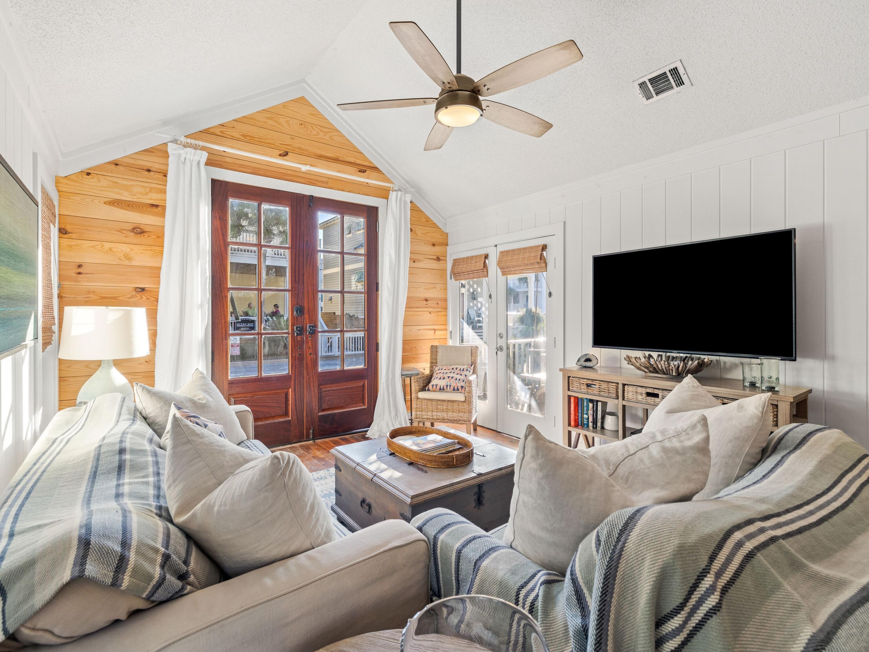 50 Cottage Street Santa Rosa Beach, FL 32459 - Photo 23 of 54 a living room with furniture a flat screen tv and a large window