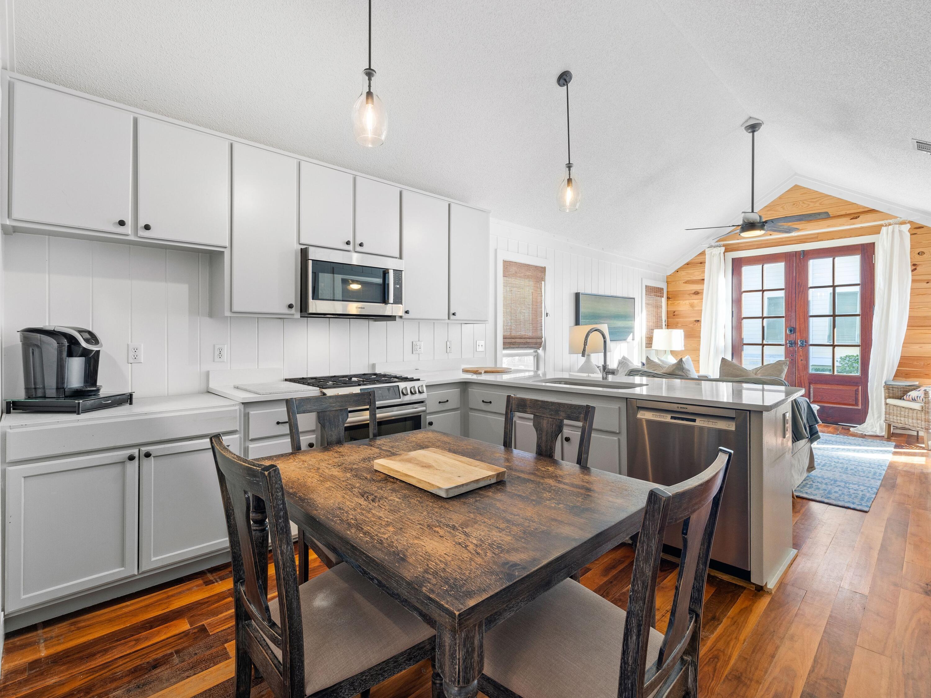50 Cottage Street Santa Rosa Beach, FL 32459 - Photo 26 of 54 a kitchen with granite countertop a dining table chairs and granite counter tops