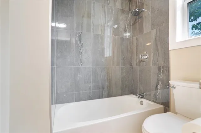 a bathroom with a bathtub and a toilet